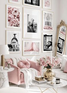 a living room filled with lots of pictures and flowers on the wall next to a white couch