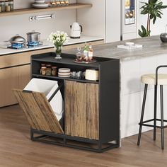 an open cabinet in the middle of a kitchen with two stools next to it