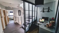 a room with a bed, desk and computer on the table in it's corner