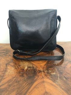 "Origo Leather purse, made in Italy, fine Italian leather, black leather Crossbody, shoulder bag Three large main compartments, one has a zippered pocket and the other side has an organizer.Also one large zippered pocket under front flap. PLEASE SEE MEASUREMENTS: Measures 9\"x 8\" x 4\" Strap adjustable: drop 20\" Excellent condition AJ909DN Origo Leather purse, made in Italy, fine Italian leather, black leather Crossbody, shoulder bag" Black Rectangular Shoulder Bag With Leather Lining, Black Soft Leather Rectangular Saddle Bag, Black Rectangular Soft Leather Saddle Bag, Black Rectangular Flap Bag With Leather Lining, Black Satchel Flap Bag With Leather Lining, Black Flap Satchel Bag With Leather Lining, Black Leather-lined Satchel Flap Bag, Black Flap Bag With Leather Lining For Everyday Use, Perfect Together