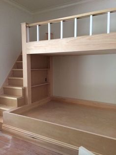 an empty room with stairs leading up to the top floor and bottom bunk above it