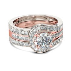 a diamond engagement ring set with two bands and a round center stone on the side