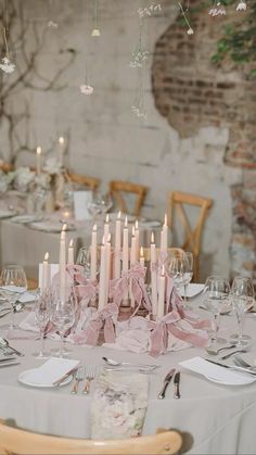 the table is set with candles and place settings