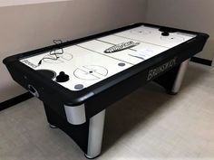 an air hockey table in the corner of a room