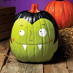 there is a green pumpkin with two faces on it