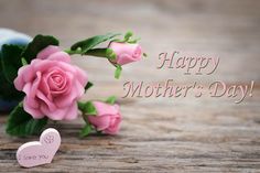 a pink rose is sitting next to a bottle with a heart on it and the words mother's day written in red