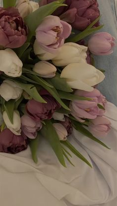 a bouquet of tulips and other flowers on a bed