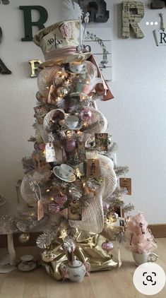 a small christmas tree with many ornaments on it