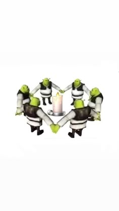 three people sitting around a candle in the shape of a heart with their hands together