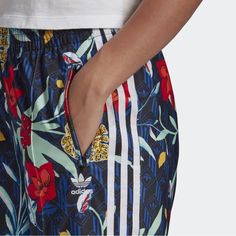 When Her Studio London Is Involved, You Know That Means Bold Colours And Wild Prints. So No Surprise That These Adidas Track Pants Stand Out Wherever You Are. A Continuation Of Our Collaboration With The Powerhouse Studio, These Adidas Pants Get Totally Revamped With Their Signature Expressive Style. The Shiny Tricot Build Shows Off A Loud Floral Print, With Signature Contrast Details That Pop Against It. Pure Adidas. Pure Style. Adidas Summer Bottoms With Pockets, Adidas Pants With Elastic Waistband For Spring, Adidas Wide Leg Bottoms For Spring, Adidas Pants For Spring, Adidas Summer Bottoms With Elastic Waistband, Adidas Bottoms With Elastic Waistband For Summer, Summer Adidas Bottoms With Elastic Waistband, Adidas Spring Pants With Pockets, Adidas Spring Bottoms With Pockets