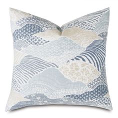 a blue and white pillow with waves on it