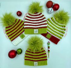 three knitted hats and ornaments on a white surface