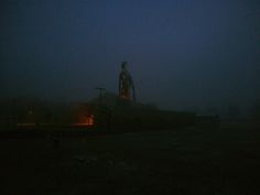 a man standing on top of a hill in the dark