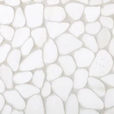 a close up view of a white stone wall with small rocks on the bottom and sides