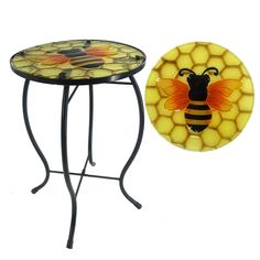 a small table with a bee on it next to a plate that has a honeybee on it