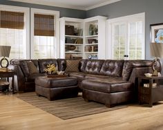 a living room filled with furniture and windows