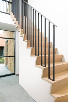 a set of wooden stairs with black railings