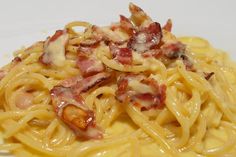 pasta with bacon and cheese on a white plate