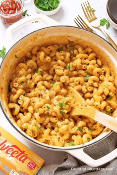 macaroni and cheese is being stirred in a pot