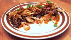 a white plate topped with food on top of a wooden table