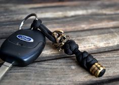 a car keychain with a ford logo on it sitting on a wooden surface