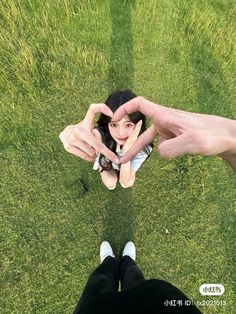 two people making a heart with their hands