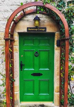 a green door with an arched wooden frame