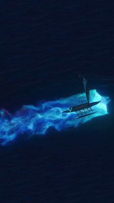 an aerial view of a boat in the ocean with blue lights on it's side