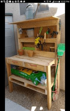 a potting bench made out of pallets with gardening tools on top and in the back