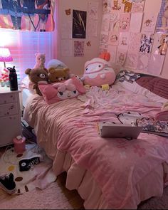 a bed with pink sheets and lots of stuffed animals on it in a bedroom next to a window