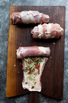 two pieces of raw meat on a cutting board