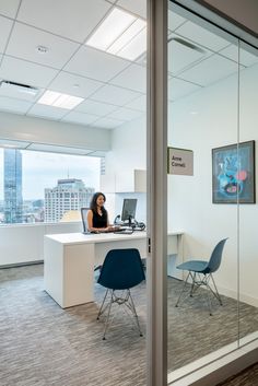 a woman sitting at a desk in an office