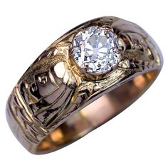 Circa 1890 This highly unusual antique 14K gold ring is chased with two profile busts of an Egyptian pharaoh and stylized floral designs. The ring is prong set with a sparkling old European cut diamond (J color, SI2 clarity, 6.4-6.3 x 4.3 mm, approximately 1.10 ct). Width 10 mm (3/8 in.) Weight 8.75 grams Rinz size 9.5 (20 mm) Antique Mens Rings, Vintage Solitaire Engagement Ring, Stunning Diamond Rings, S Ring, Mens Gold Jewelry, Mens Rings, Solitaire Rings, Mens Gold Rings, Yellow Gold Diamond Ring