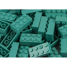 a pile of green lego blocks sitting next to each other