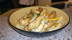 a bowl filled with pasta and chicken on top of a counter