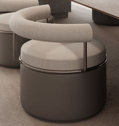 two circular chairs sitting next to each other on top of a carpeted floor in front of a wooden table