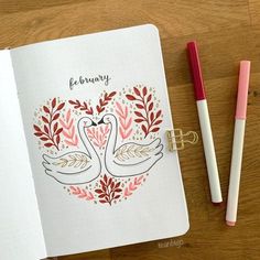 an open notebook with two swans on it