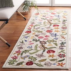 a white rug with colorful flowers on it