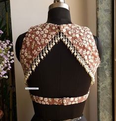 This Made to Order/Made to Measurement/Custom Made Indian Ethnic Blouse. - Fabric - Embroidered Net - Color - Mauve Brown with off-white embroidery - Padded - Princess Cut - Jewel Neck - Lined - Back Hook Closure - Backless with beads embellishment - Extra margin and extra stitches included in the blouse PLEASE NOTE: BUYERS ARE RESPONSIBLE FOR ANY CUSTOMS AND IMPORT TAXES THAT MAY APPLY. This is a made to order product. If you opt for 'Made To Measurement Option', we will provide a measurement template and you can share the measurements likewise. If you want to opt for 'Standard Size', Please refer to the size chart provided in the listing. Shipping: Standard Shipping is done by DHL ecommerce and it mostly takes 2 to 3 weeks to deliver after dispatch. Express Shipping is done by DHL expres Blouse Back Neck Net Designs, Sleeveless Unstitched Blouse For Festival, Traditional Floral Embroidered Sleeveless Blouse, Embroidered Sleeveless Choli, Bohemian Fitted Sleeveless Blouse Piece, Fitted Bohemian Sleeveless Blouse Piece, Fitted Sleeveless Blouse With Intricate Embroidery, Sleeveless Fitted Blouse Piece With Intricate Embroidery, Embroidered Sleeveless Summer Choli