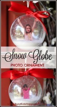 snow globe photo ornament hanging from a red ribbon with the words snow globe on it