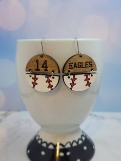 the earrings are made out of wood and have baseballs on them