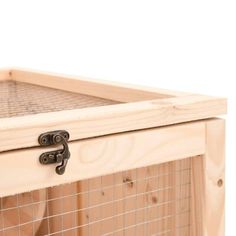 a close up of a cat in a wooden crate with wire on the top and bottom