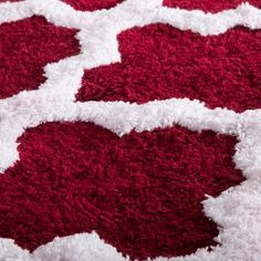 a red and white rug with circles on it