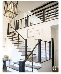 an image of a staircase with pictures on the wall and stairs in the bottom right corner