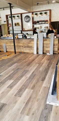 the inside of a restaurant with wood flooring