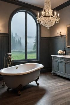 a bathroom with a tub, chandelier and large window in the middle of it