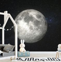 a child's room with a large moon and stars in the sky