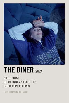 a man laying on top of a blue couch in front of a white poster with the words, the diner