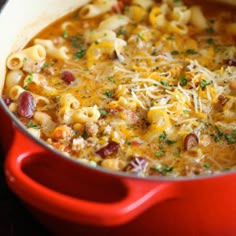 a red pot filled with macaroni and cheese