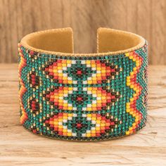 a colorful beaded bracelet on a wooden table